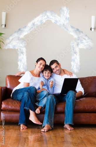 Family using a laptop with thumbs up and copyspace