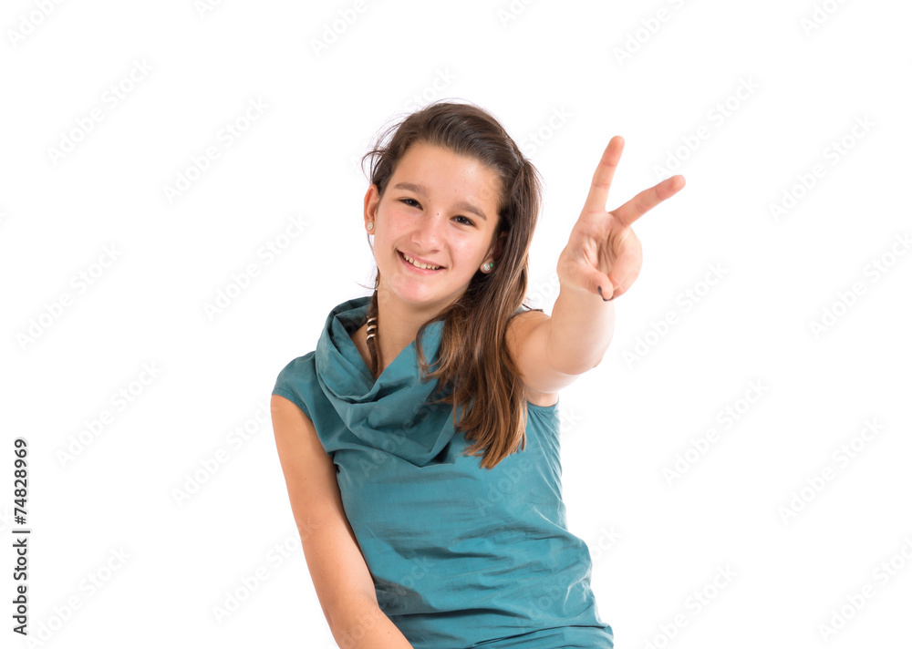 Girl doing victory gesture over white background Girl doing victory gesture over white background