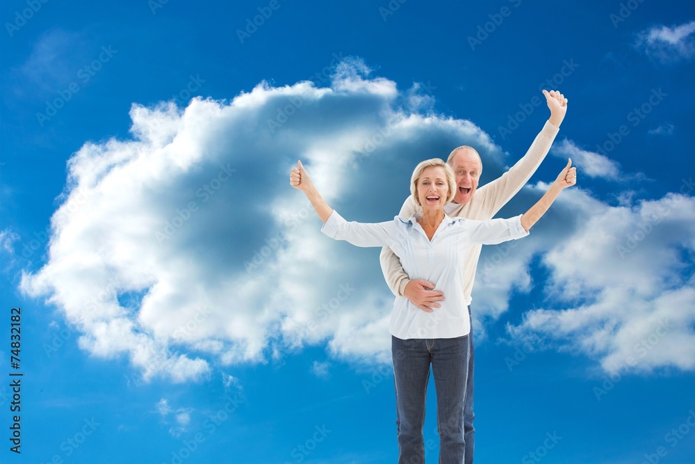 Composite image of happy mature couple cheering at camera Composite image of happy mature couple cheering at camera