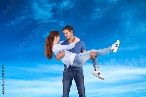Composite image of man lifting up his girlfriend