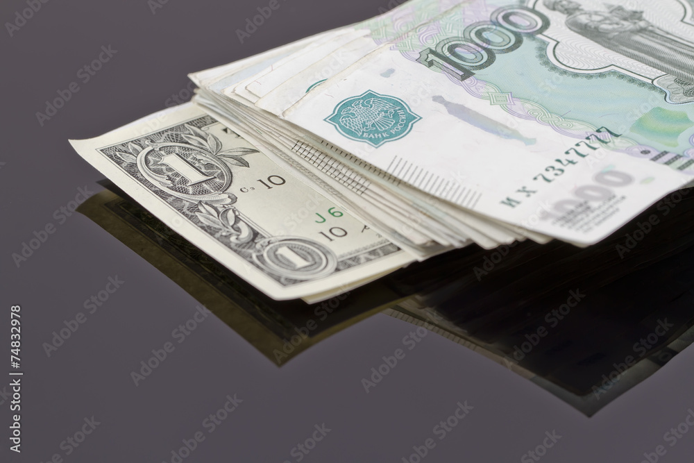 A stack of Russian rubles and one dollar A stack of Russian rubles and one dollar