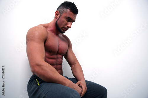 Portrait of a pensive muscular man over gray background