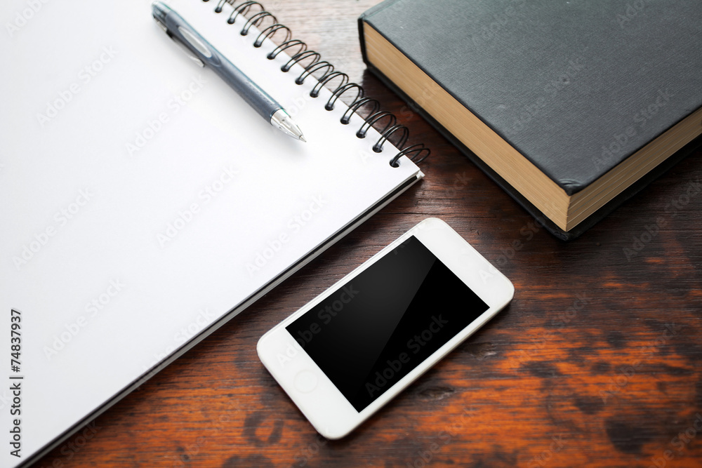 Blank notebook and mobile phone on wood table Blank notebook and mobile phone on wood table