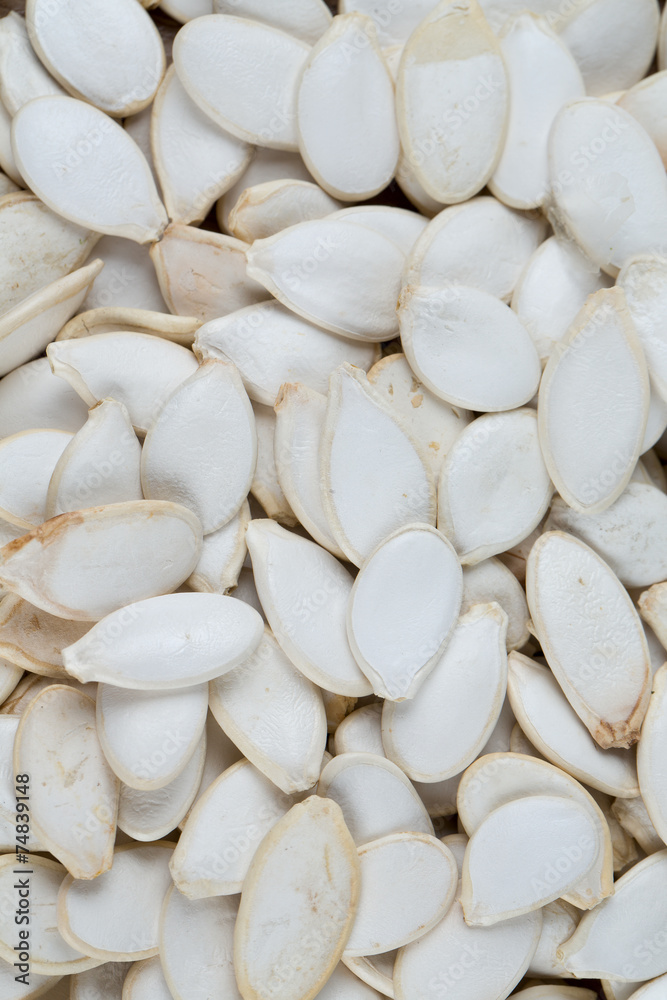 pumpkin seeds on wooden surface pumpkin seeds on wooden surface