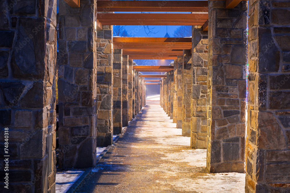 Fototapeta premium Pedestrian path with stone wall perspective
