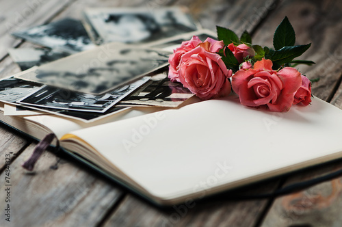 Photoalbum with rose on Wooden table