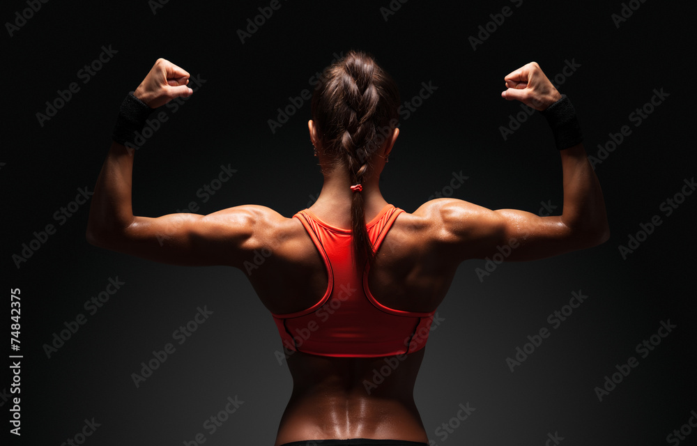 Muscular active athletic young woman showing muscles of the back shoulders  and hands fitness, sport, training lifestyle concept. Stock Photo by  ©undrey 73458819