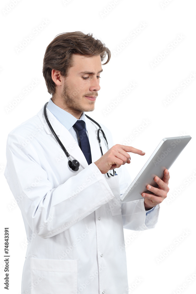 Serious doctor man browsing a tablet reader Serious doctor man browsing a tablet reader