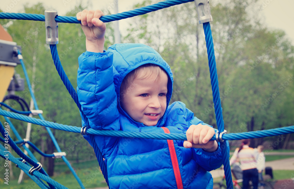 little boy climbing rope on the playground little boy climbing rope on the playground