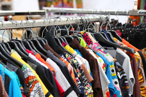 vintage clothes of many colors for sale at flea market