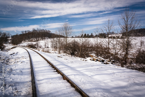 Snow covered railroad tracks in rural Carroll County, Maryland. © jonbilous