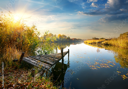 Obraz na płótnie Old pier on autumn river w salonie