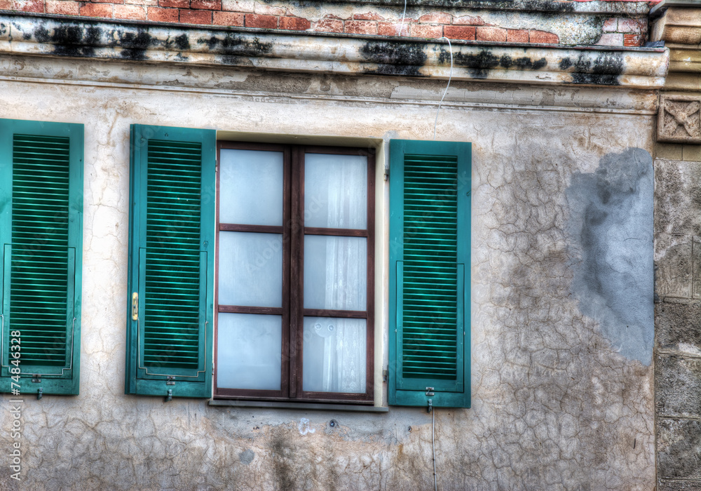 Fototapeta premium green shutters in a rustic wall