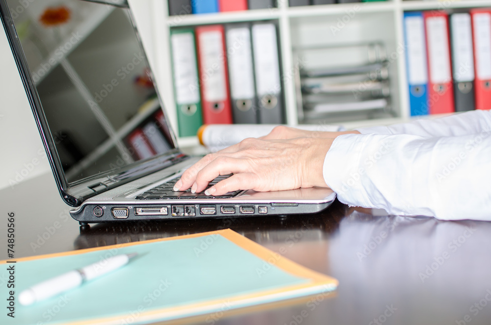 Businesswoman typing on a laptop Businesswoman typing on a laptop