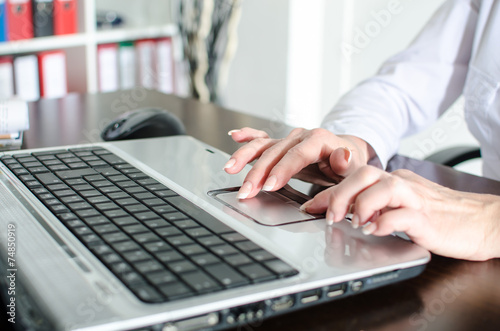 Businesswoman using laptop mouse © thodonal