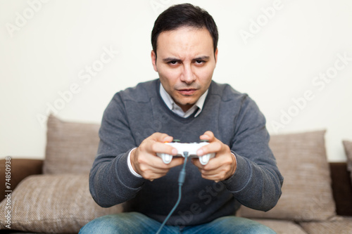 Man playing videogames on his sofa