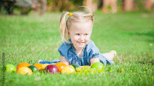 Girl eaten colorful fruits outside