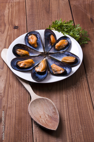 prepared mussels on wooden background