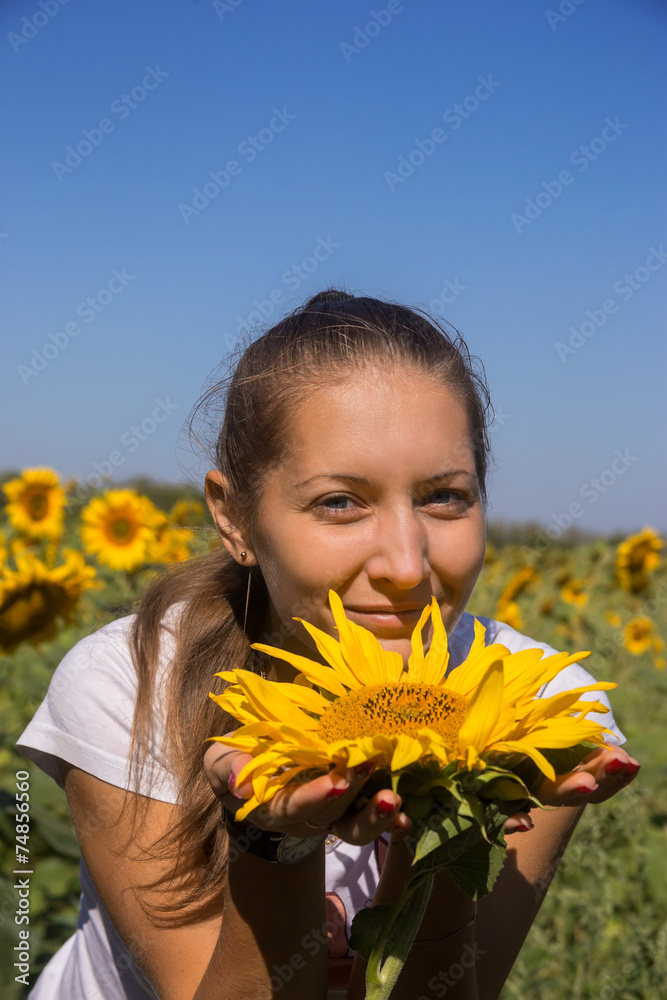 Young woman with sunflower in field Young woman with sunflower in field