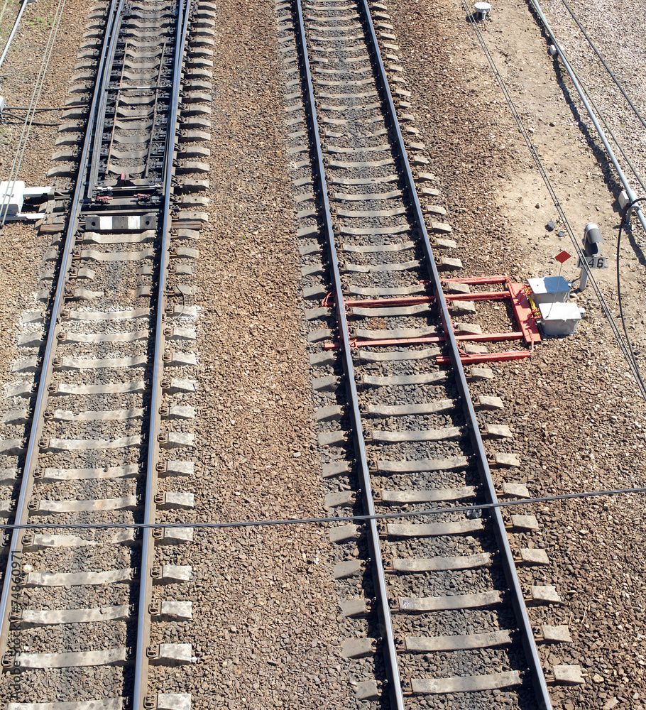 Railroad tracks on concrete sleepers, arrows