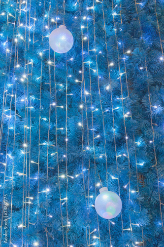 Ornamental electric light ball hanging on cristmas tree