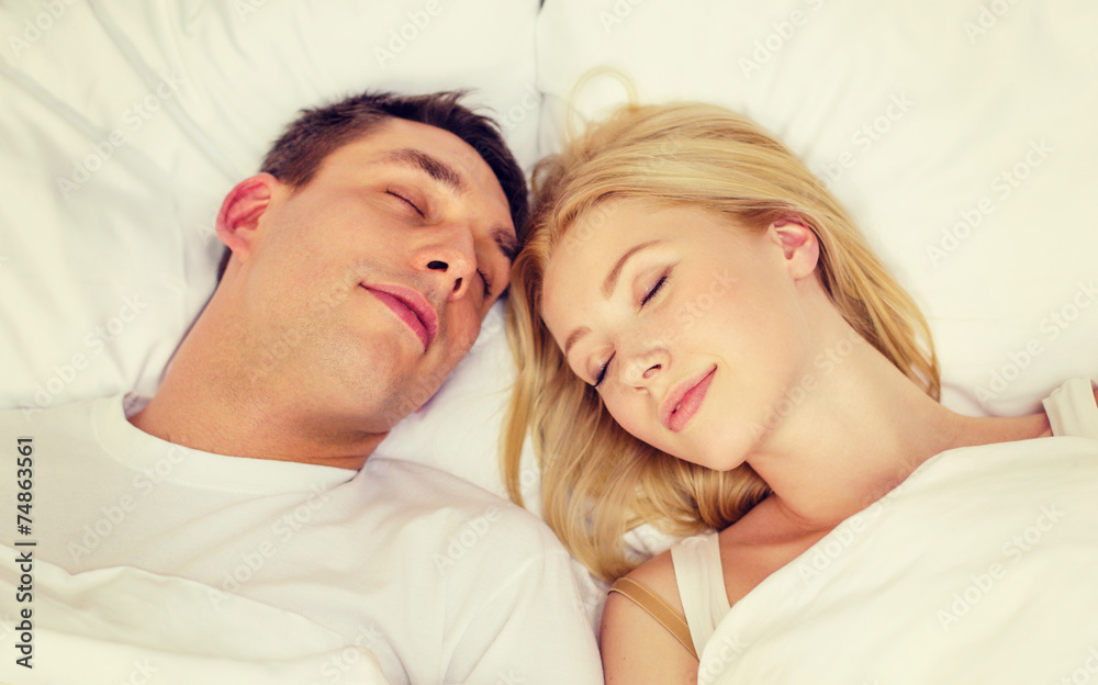 happy couple sleeping in bed