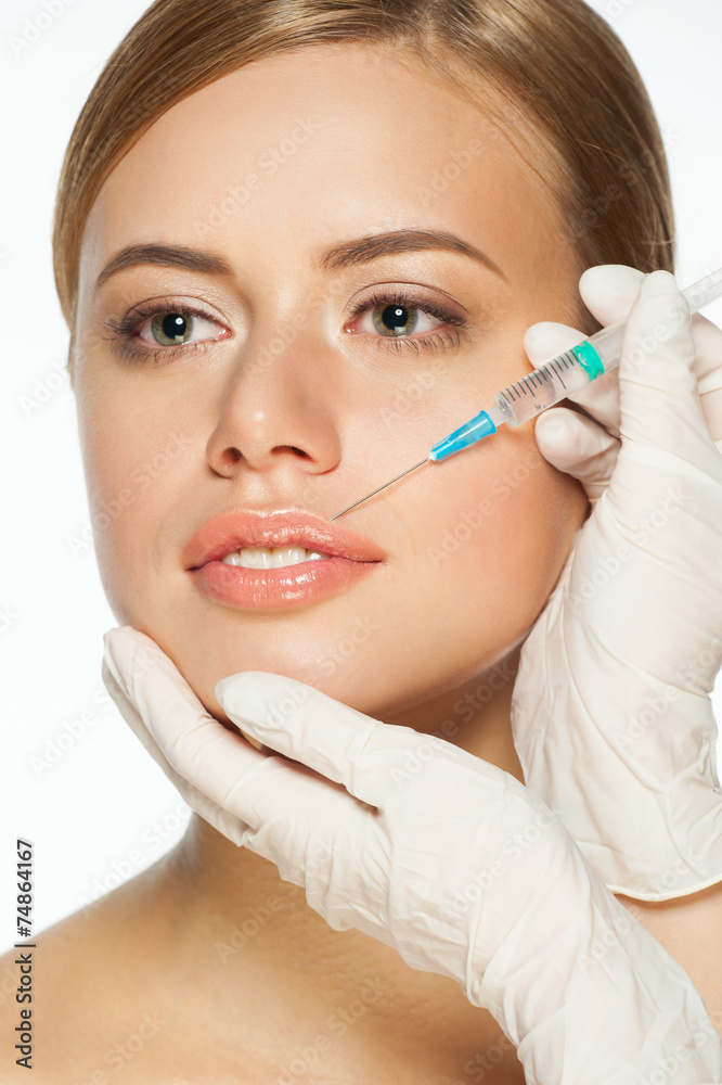 Cosmetic injection to young woman's lips