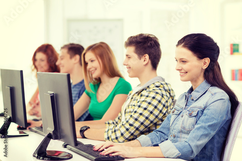 female student with classmates in computer class © Syda Productions