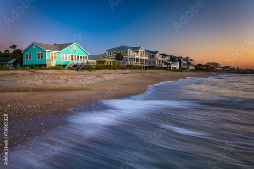 Waves in the Atlantic Ocean and beachfront homes at sunrise, Edi