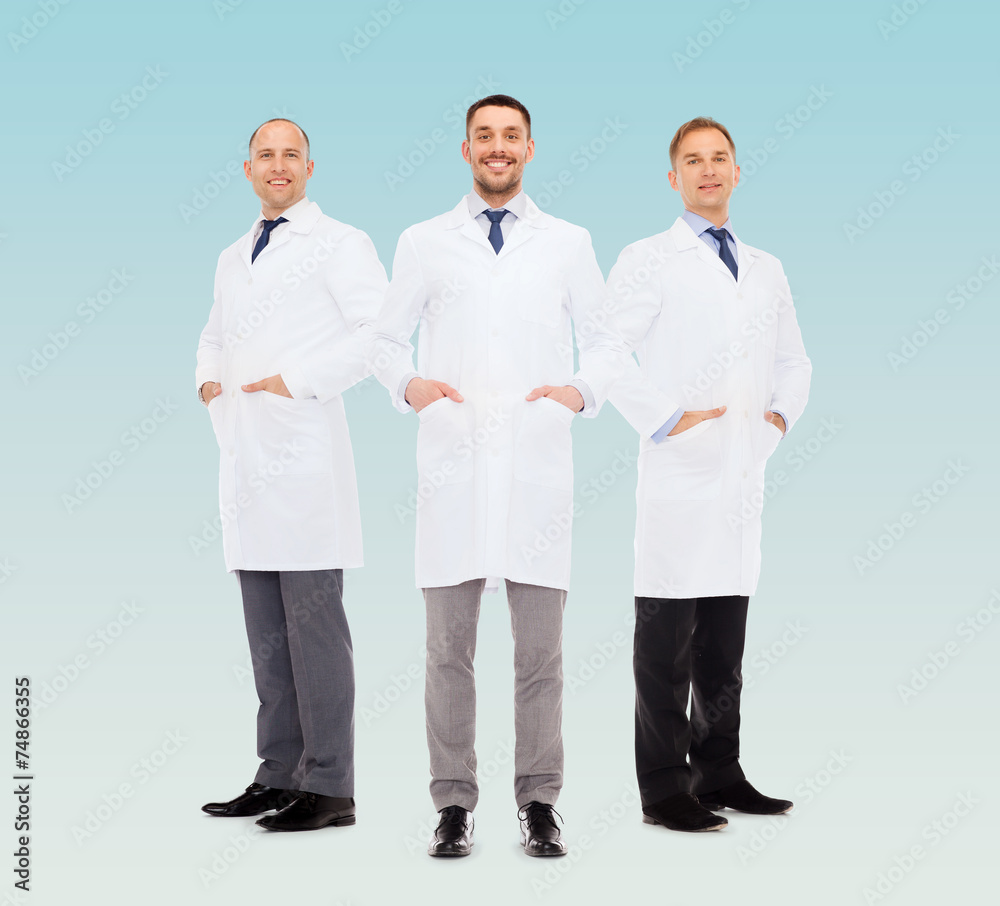 smiling male doctors in white coats smiling male doctors in white coats