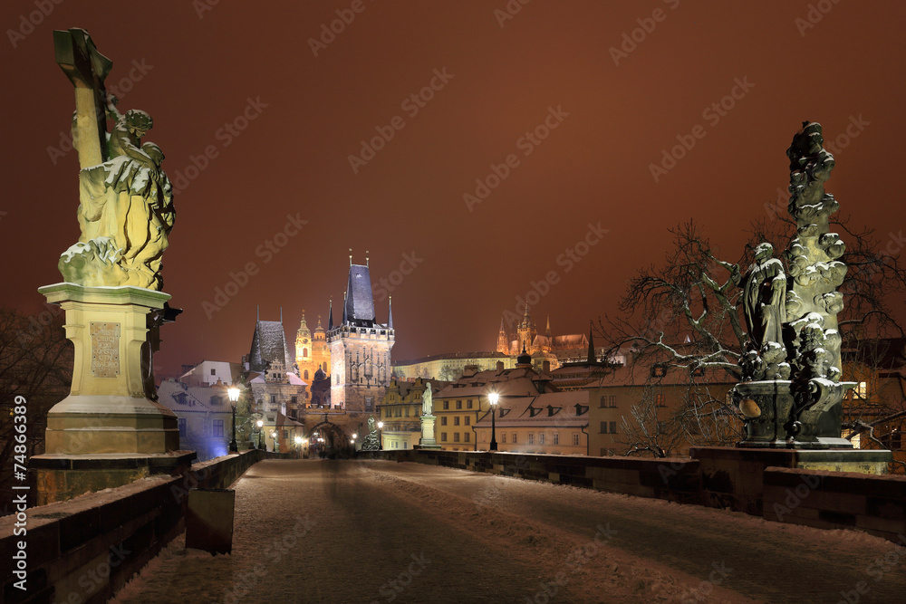Night snowy Prague Castle from Charles Bridge