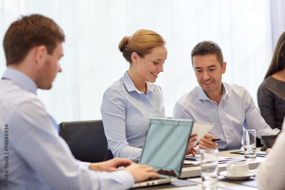smiling business people with tablet pc in office