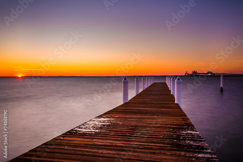 Fototapeta Naklejka Na Ścianę i Meble -  A pier at sunset, Kent Island, Maryland.