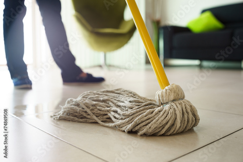 Woman Doing Chores Cleaning Floor At Home Focus on Mop