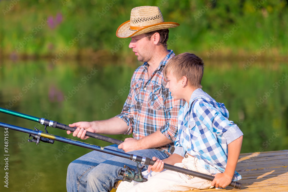 boy and his father fishing togethe boy and his father fishing togethe