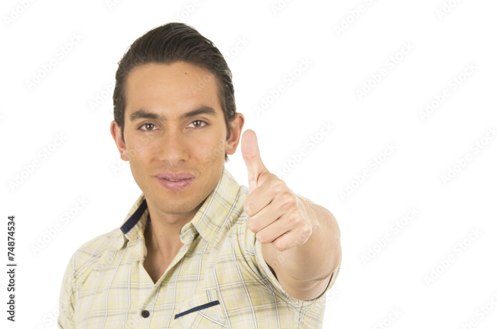 young handsome hispanic man posing with thumb up young handsome hispanic man posing with thumb up