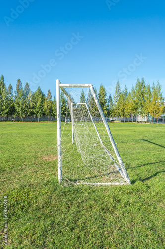 soccer goal in field with blue sky white cloud