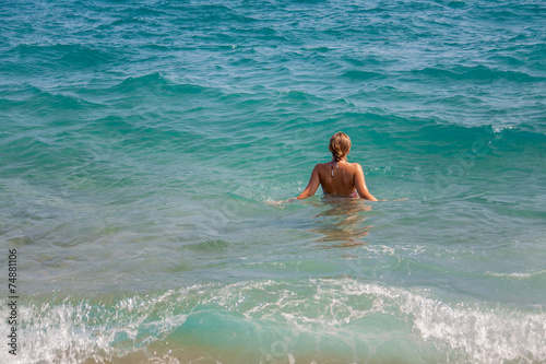 Girl enter in the sea