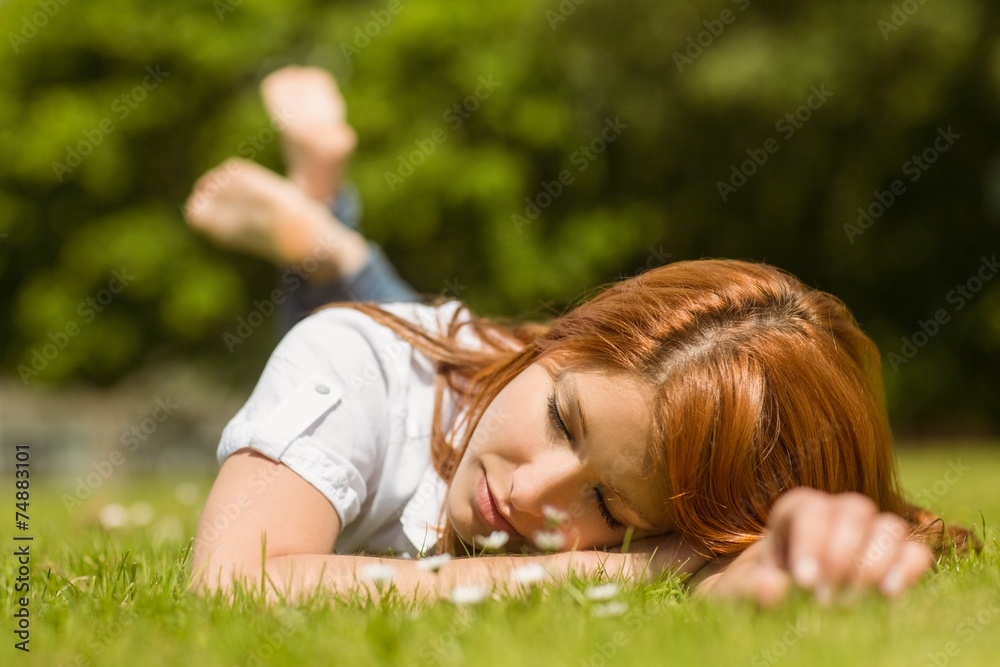 Pretty redhead napping on grass Pretty redhead napping on grass
