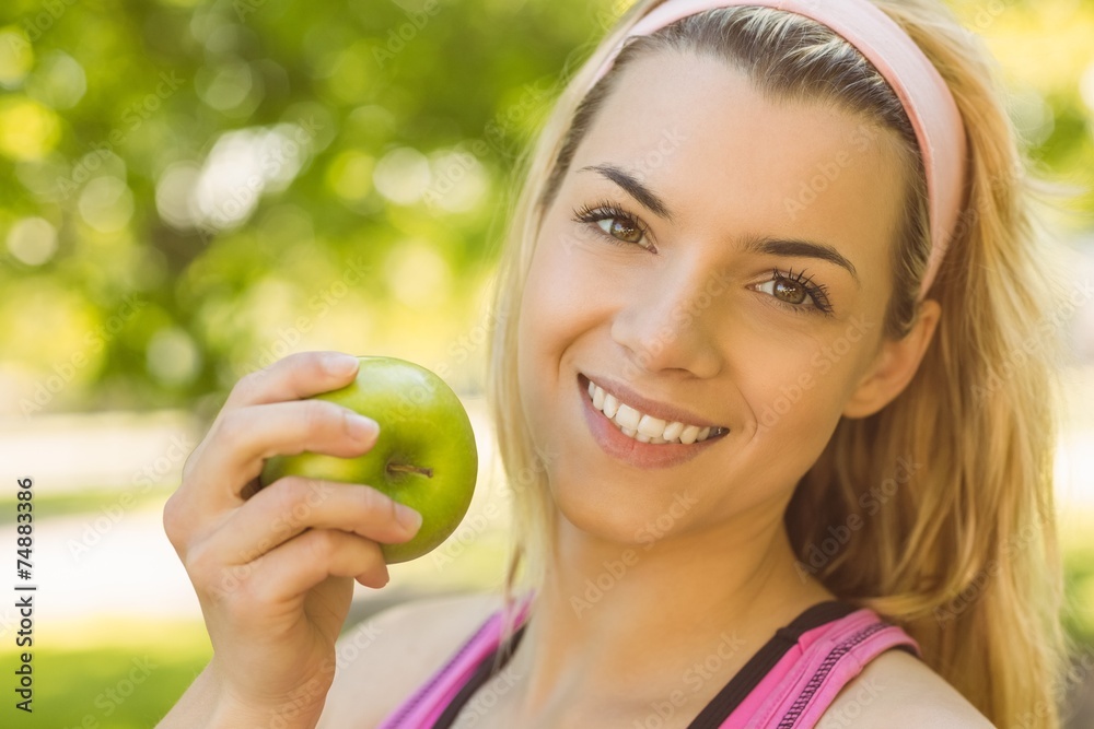 Fit blonde holding green apple Fit blonde holding green apple