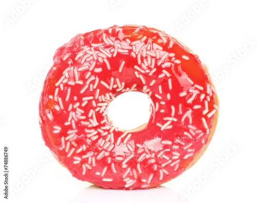Pink donut with sprinkles on white background.