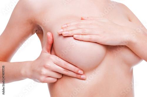 Examining breasts.
