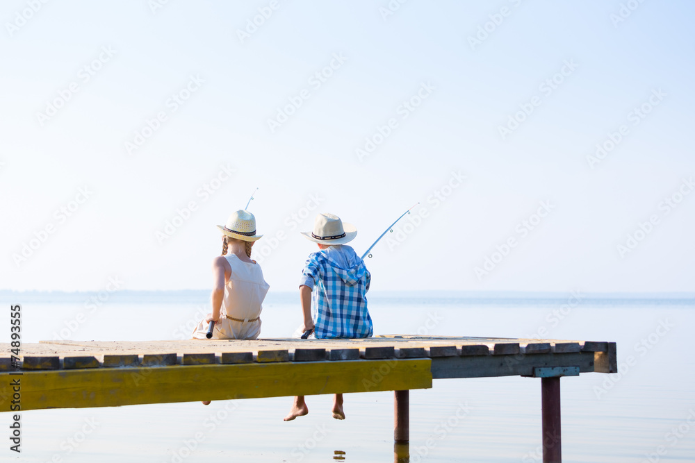 Obraz premium Boy and girl with fishing rods