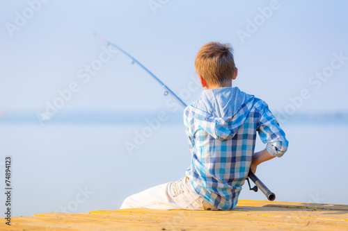 Boy in blue shirt sit on a pie