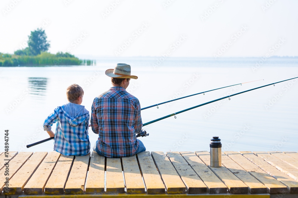 boy and his father fishing togethe boy and his father fishing togethe