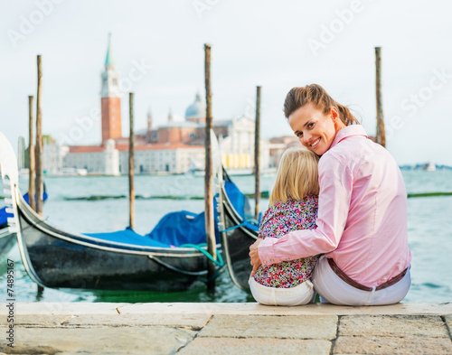 Canvas Print Portrait of mother and baby sitting on grand canal embankment