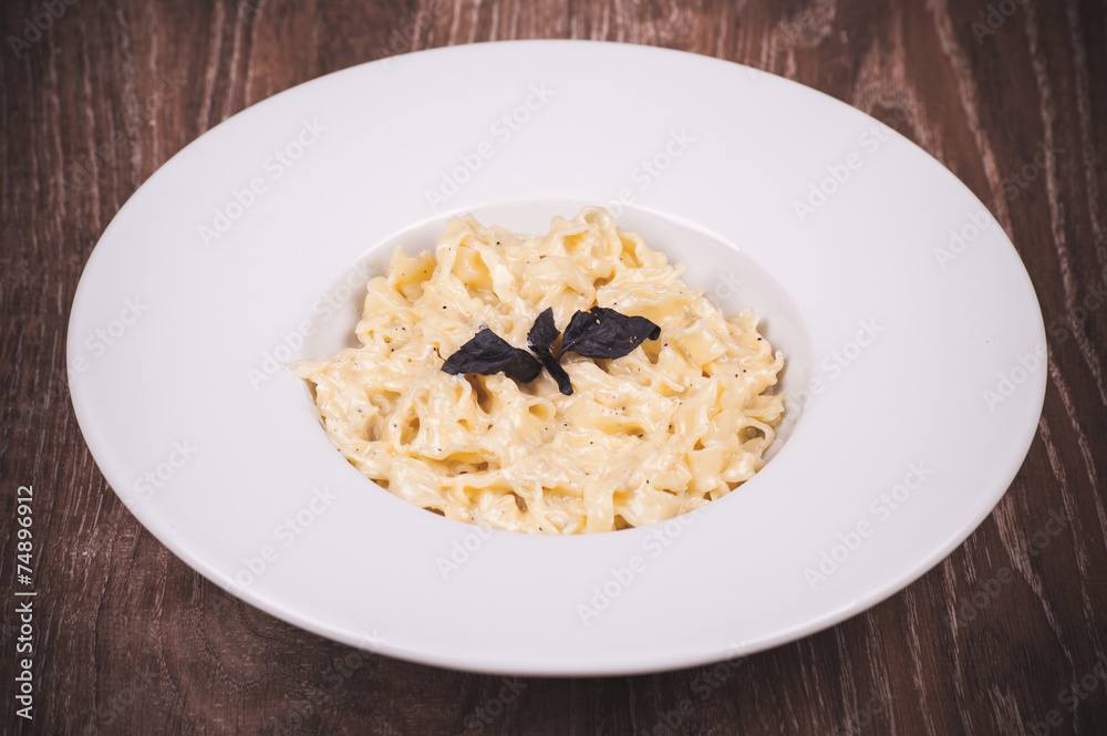 cream sauce pasta in white plate