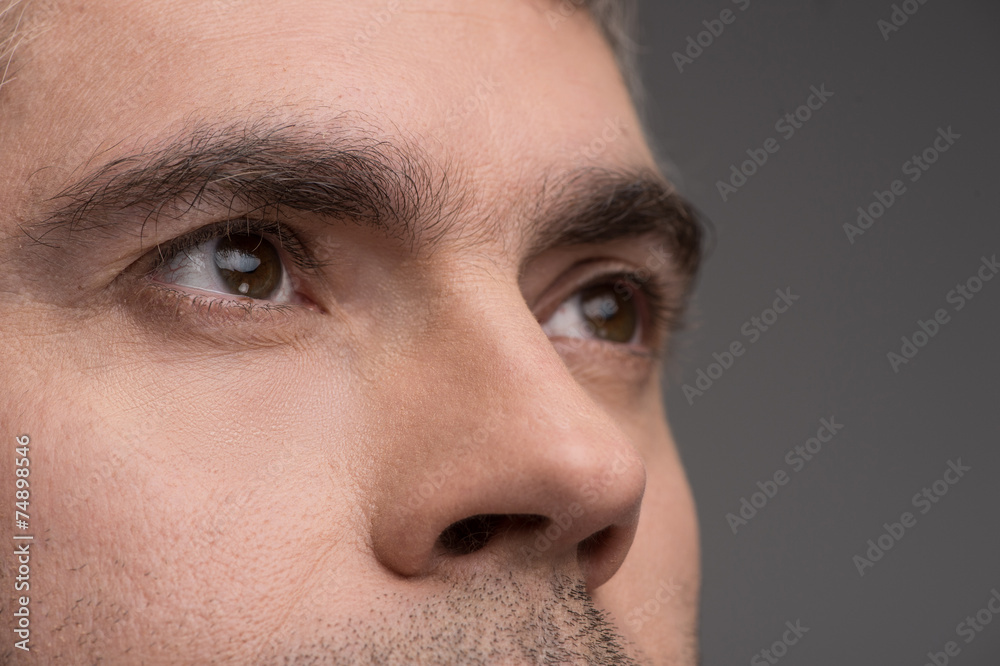 Close-up portrait of man on gray background.