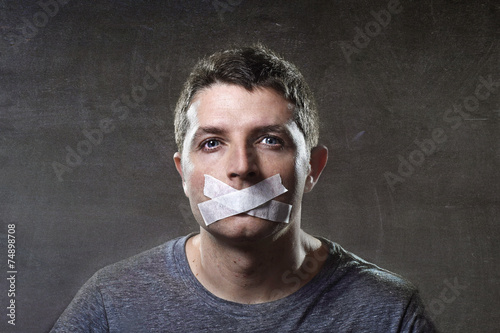 attractive man mouth sealed on tape freedom of speech concept photo