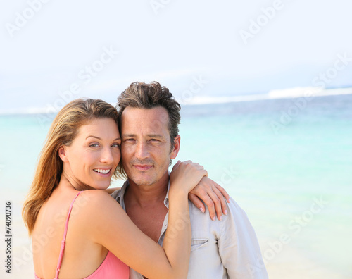 Portrait of loving middle-aged couple at the beach © goodluz